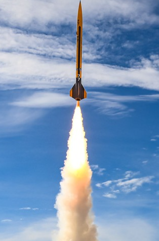 Full view of the rocket launch against blue sky